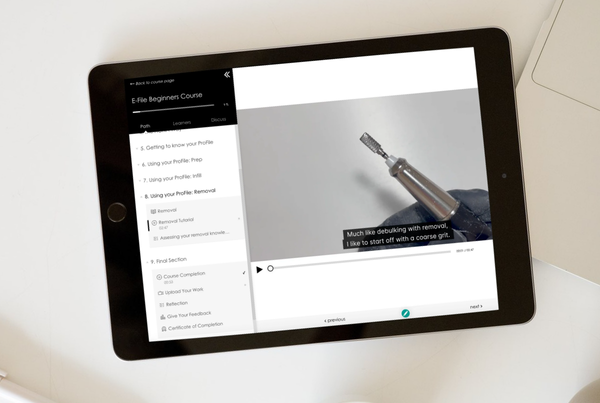 Tablet displaying a video tutorial with a close-up of a tool.