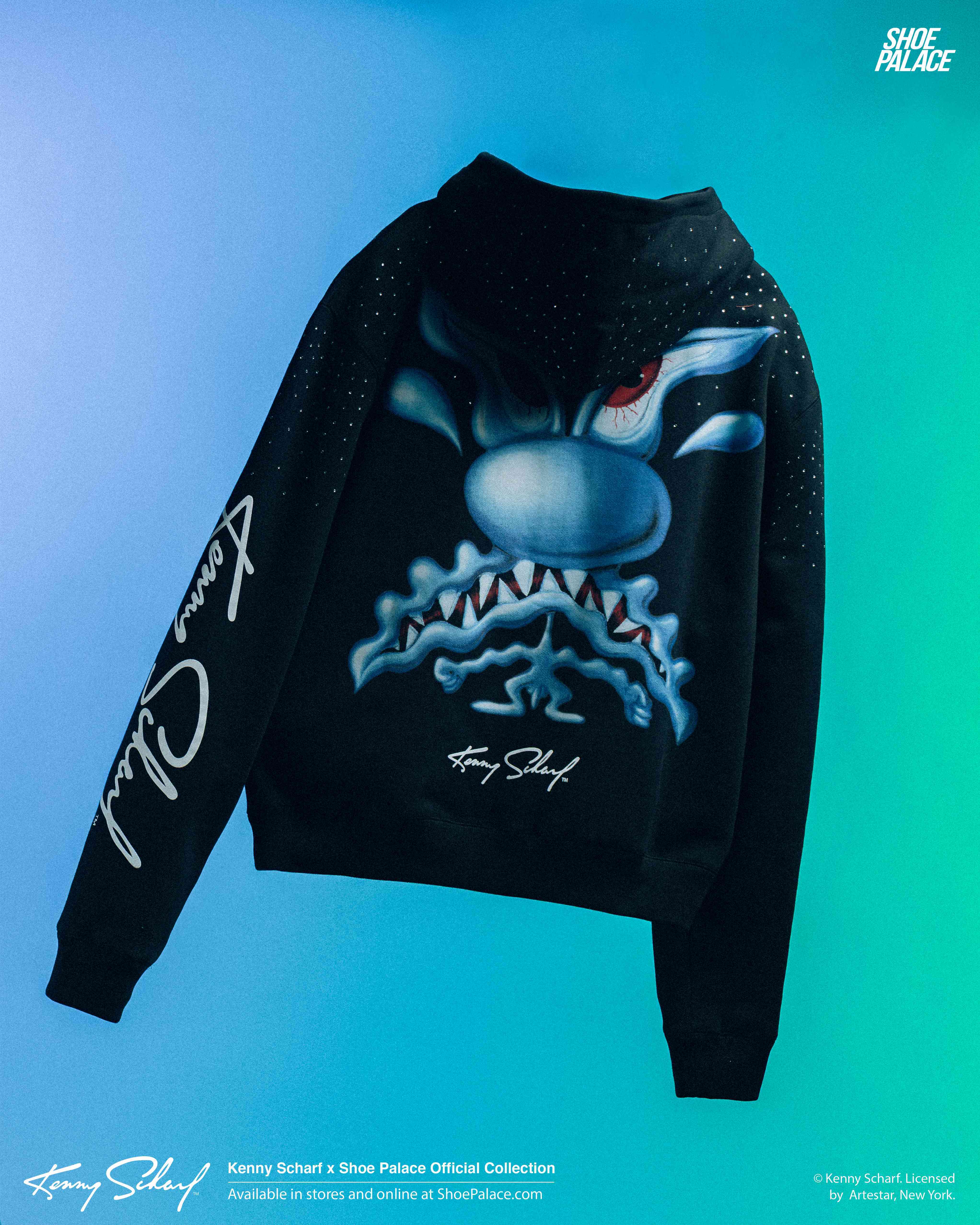 Black hoodie with a monster graphic and stylized text on sleeves.