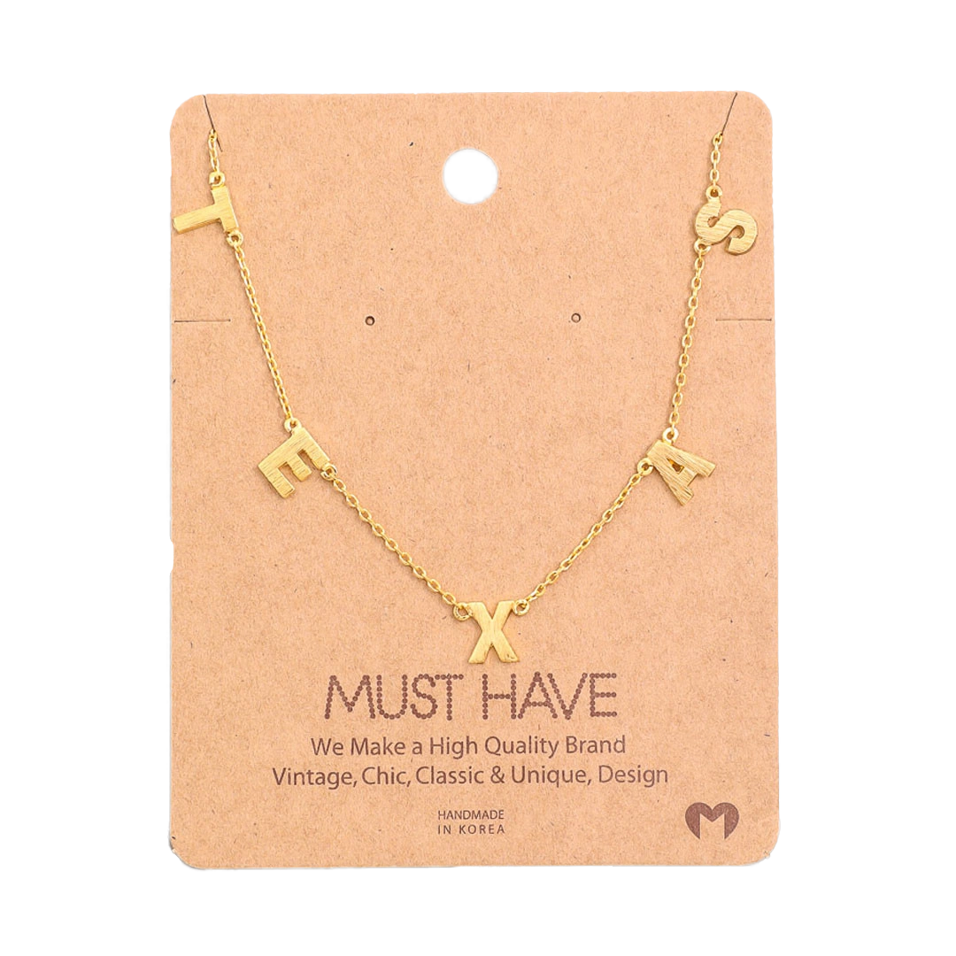 Gold necklace with letters spelling 