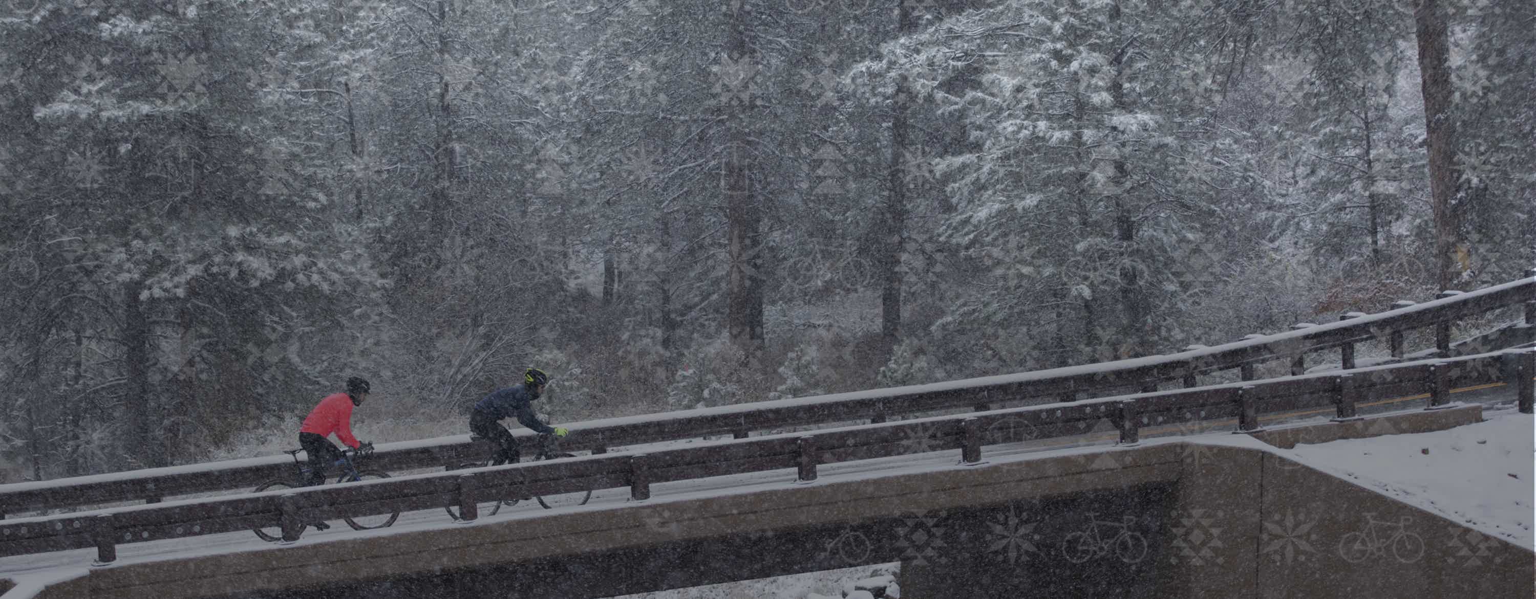 Man and a women road cycling in the snow