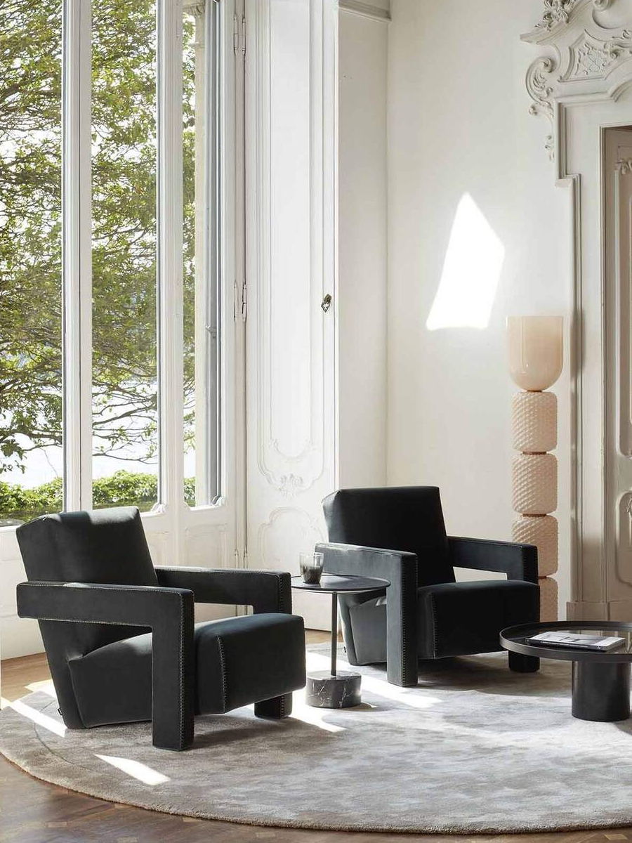 A modern orange chair in a stylish, bright living room setting.