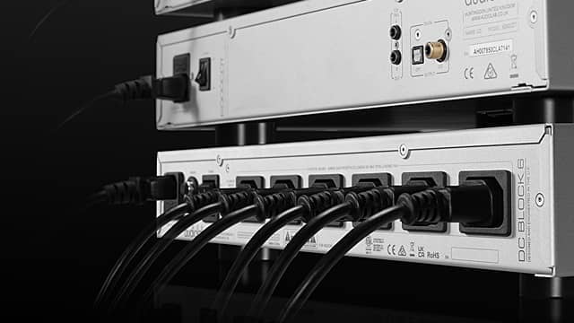 Close-up of equipment with multiple connected cables on a dark background.