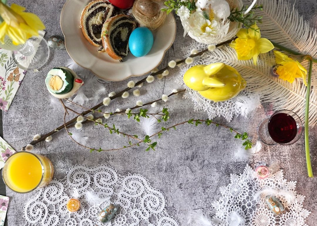 Easter table setting with cake, eggs, and flowers