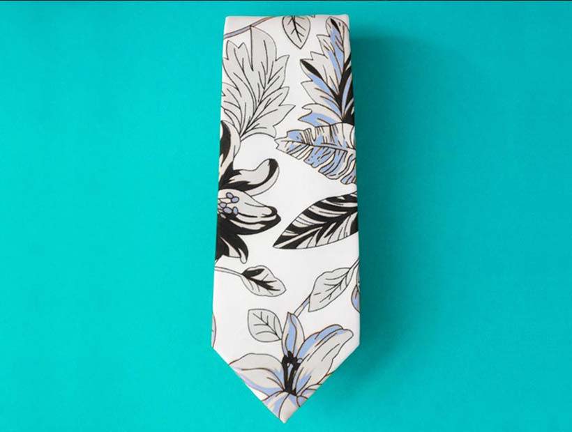 Men's floral hawaiian style tie on a turquoise plain background