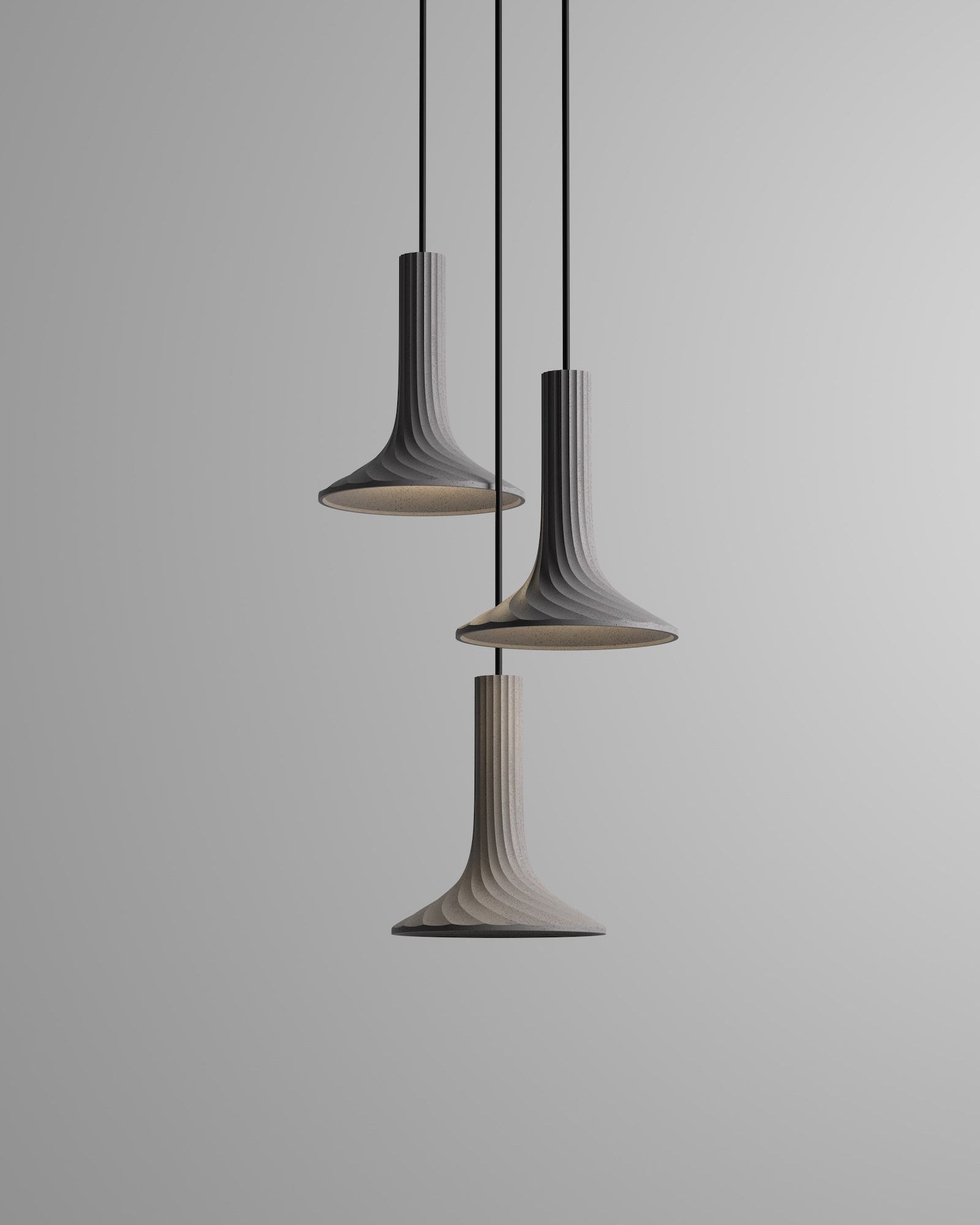 Three pendant lights hanging against a gray background