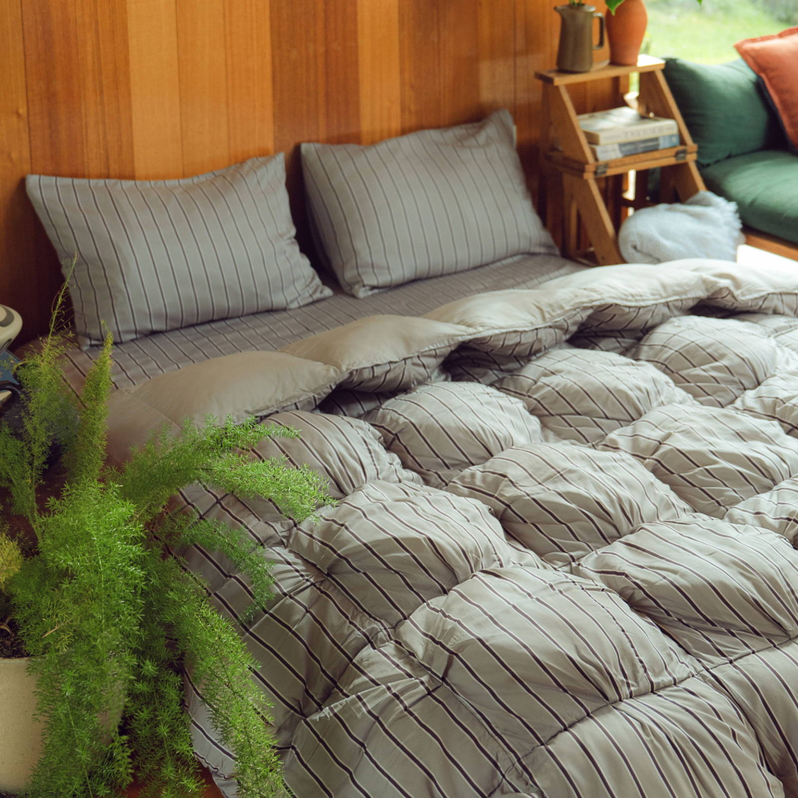 bedding set with a puffy comforter in a neutral striped print