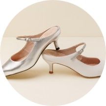 A pair of elegant high-heeled shoes in silver and white.