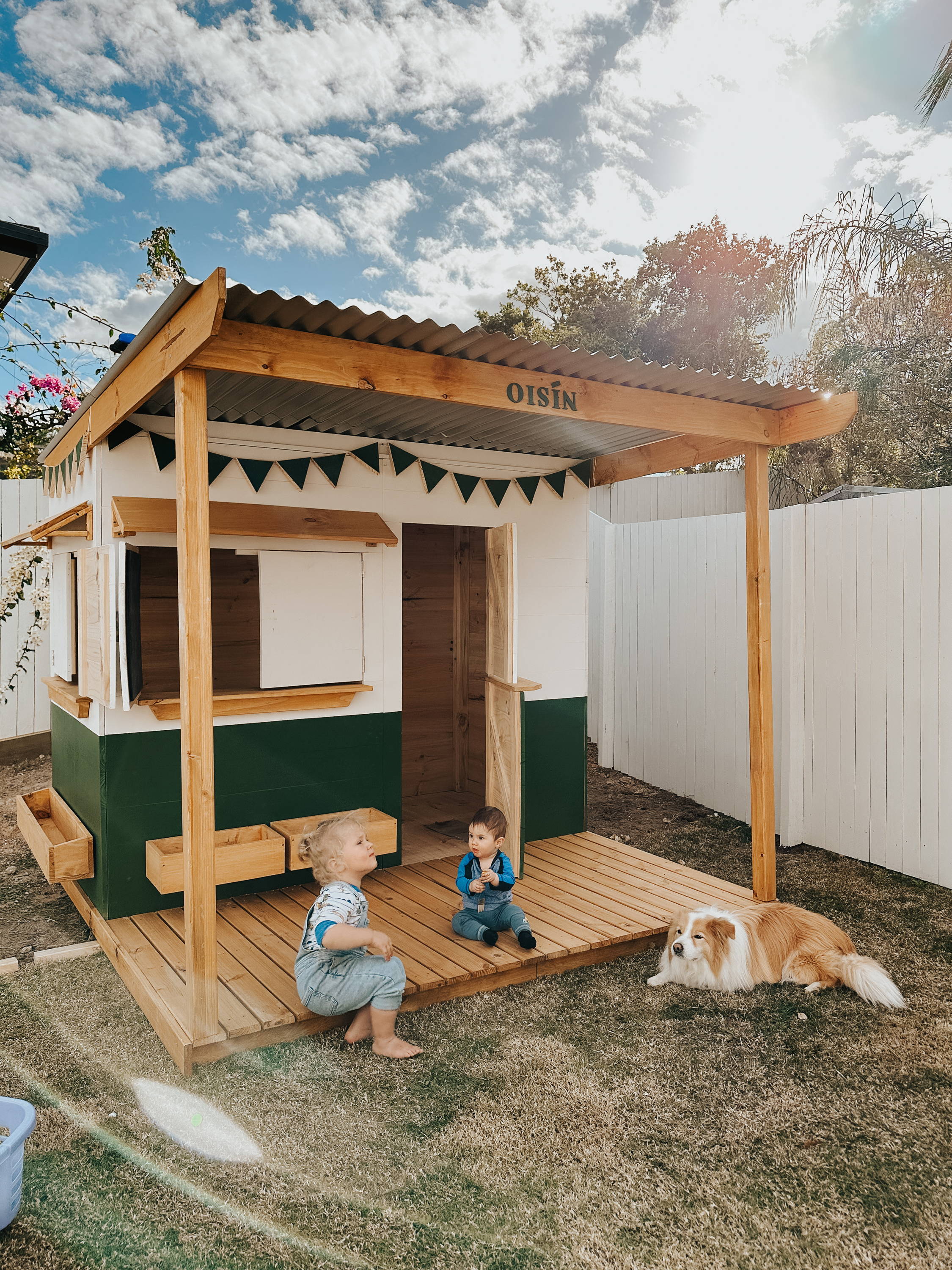 A extended cubby house with kids and a dog