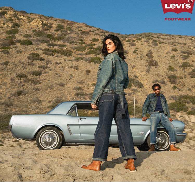 male and female models on beach with vintage car wearing levi's boots