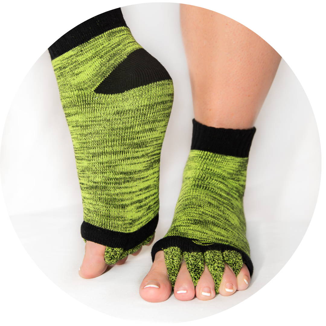 A pair of feet wearing green Happy Feet Socks