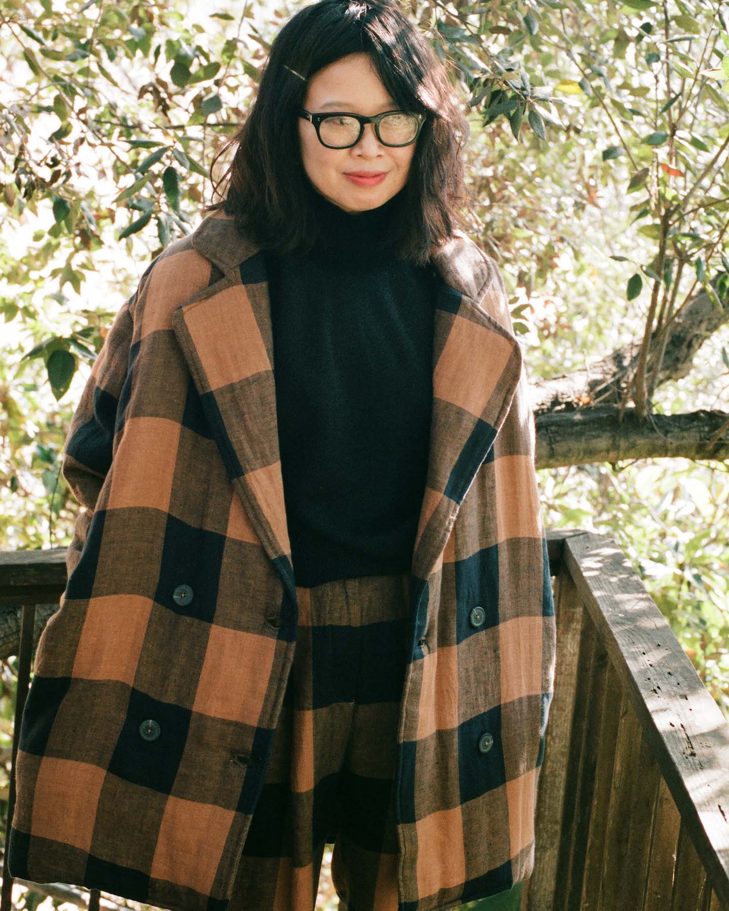 Raina Lee wearing a Mara Hoffman suit and Rachel Comey mock neck top.