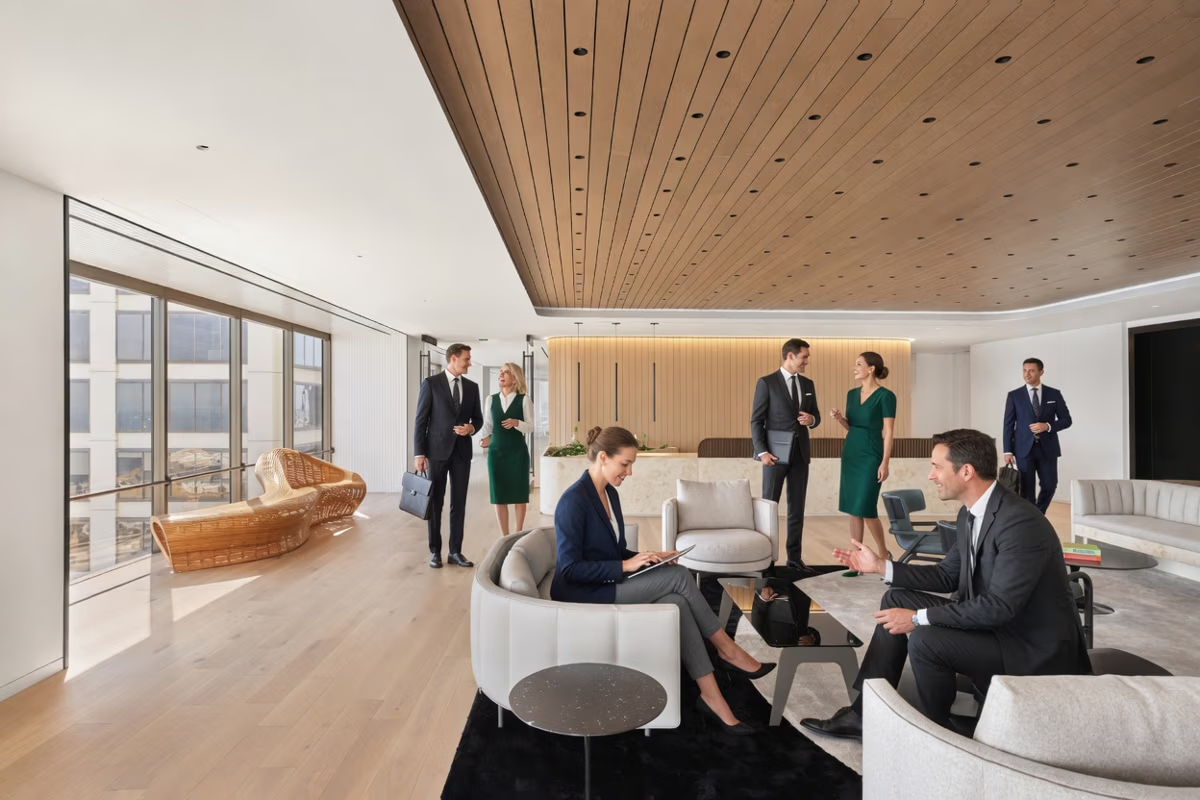 Modern office space with professionals engaged in discussions and meetings.