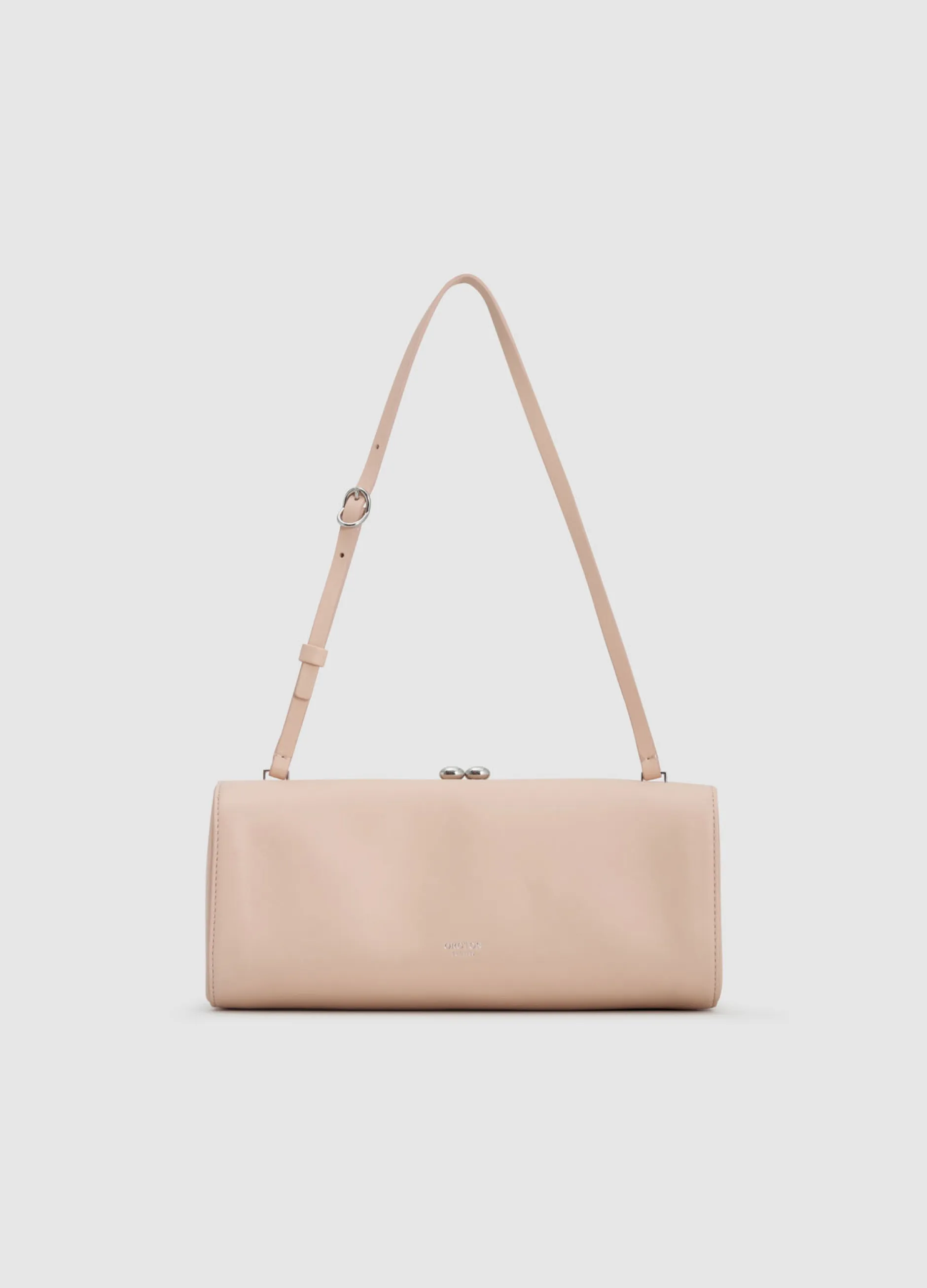 A minimalist beige handbag with a long strap.