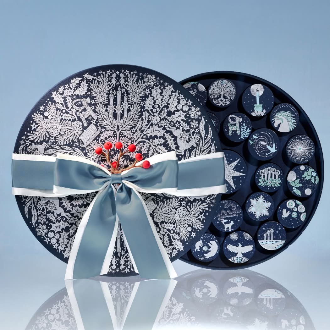 Gift box with decorative lid and assorted chocolates inside.