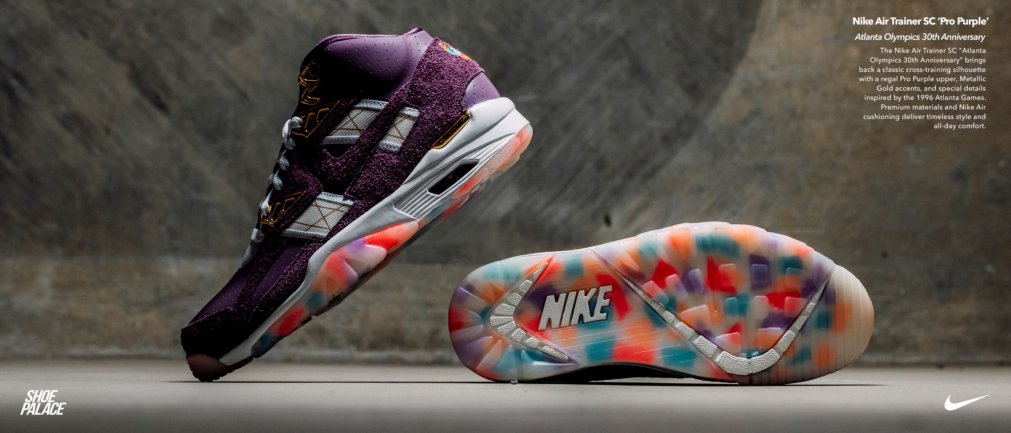 Purple Nike shoes with colorful sole, displayed against a textured background.