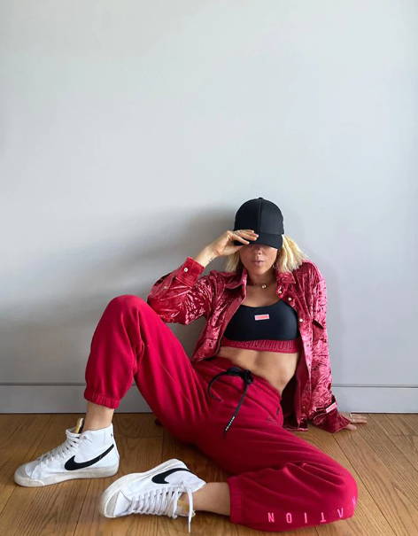 Girl sitting on the floor wearing a red outfit