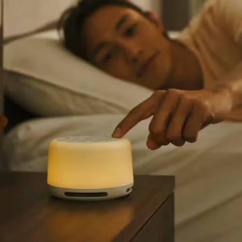 Person leaning and touching sound spa in bed