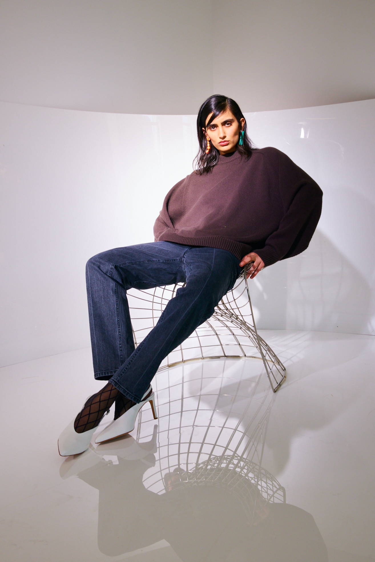 model sitting on chair  on white background