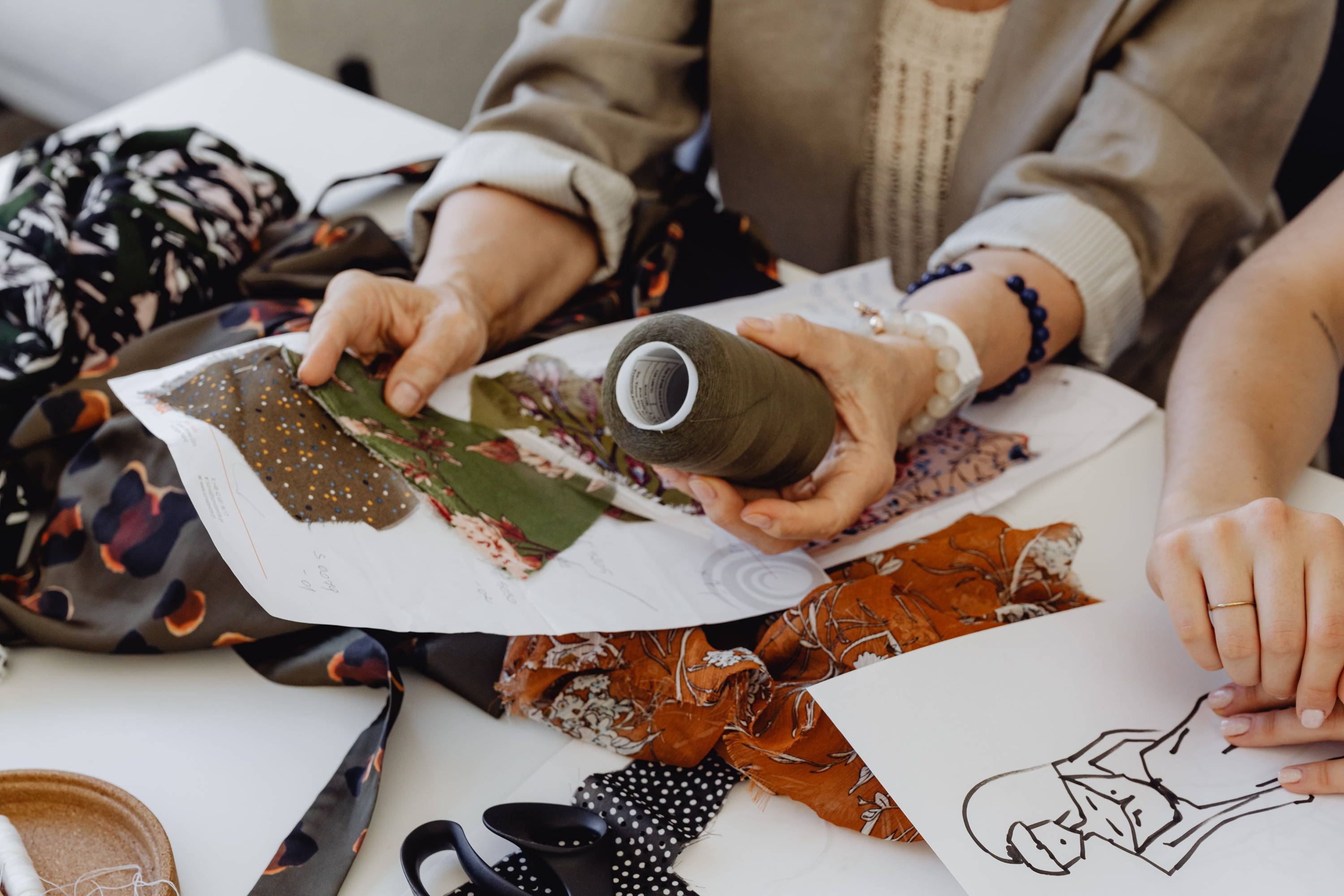 woman looking through fabrics and thread for clothes