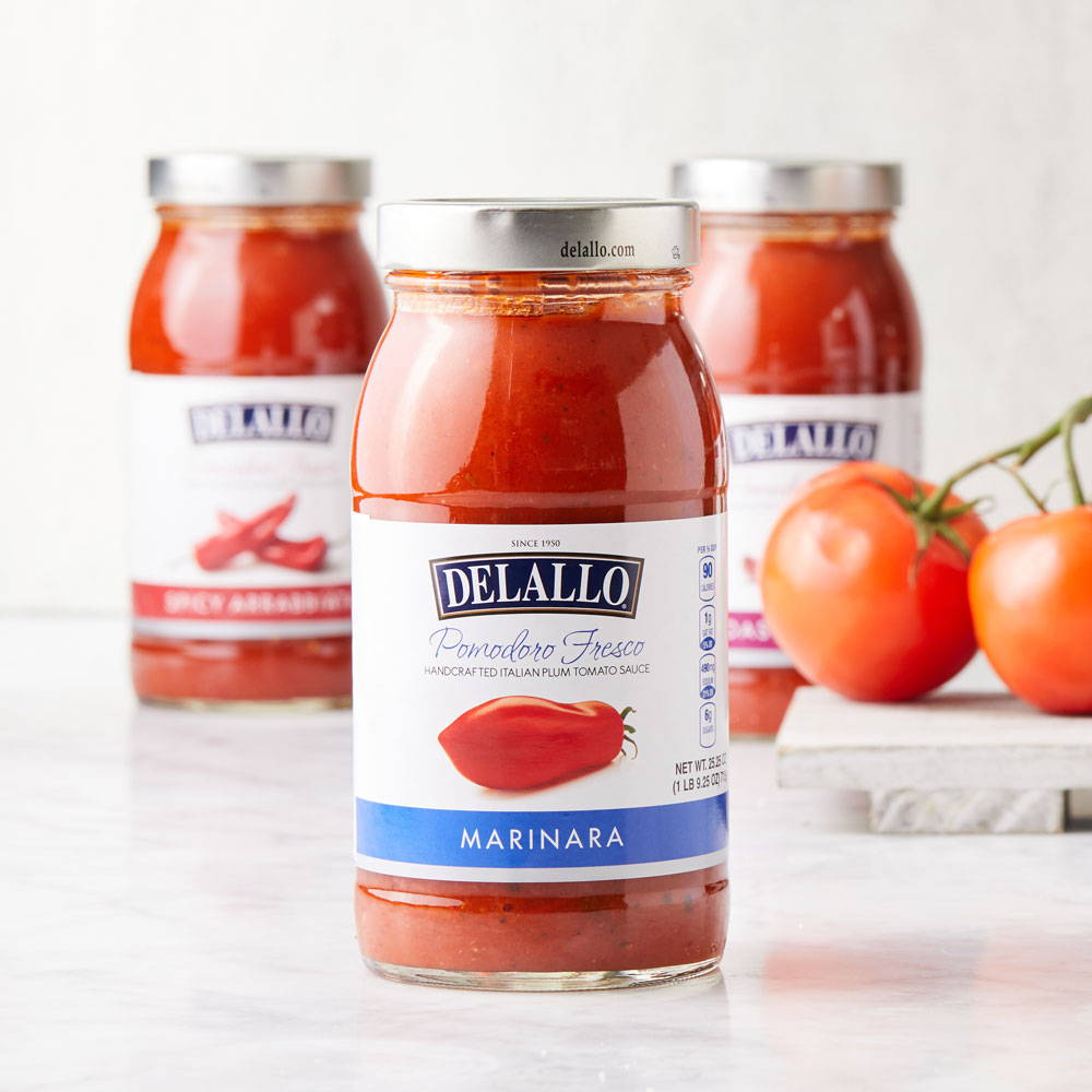 Jars of DeLallo Pasta sauces sitting on a marble table