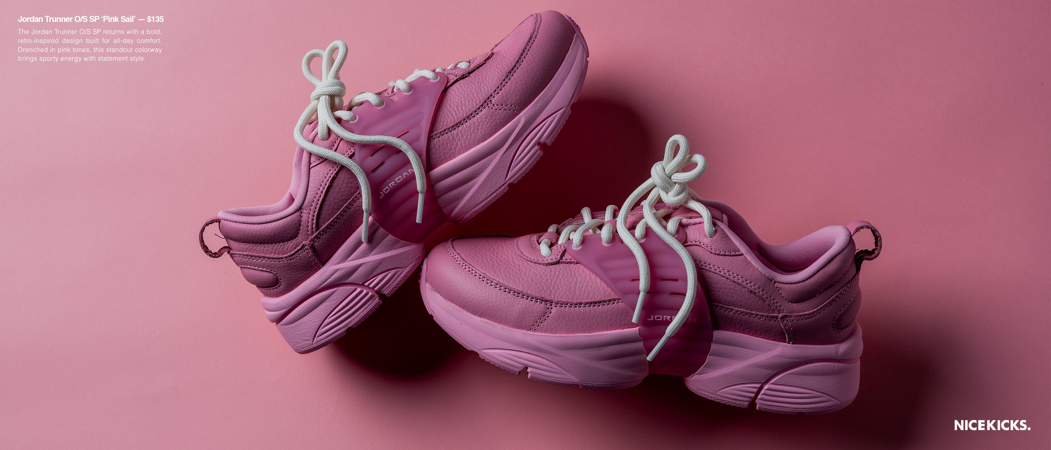Pink sneakers with white laces on a pink background.