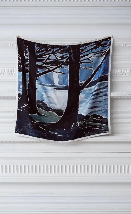 A tapestry depicting trees and a river in a twilight setting.