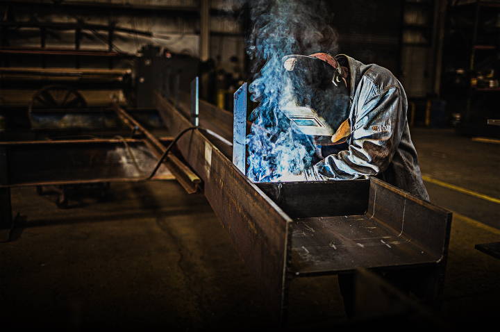 industrial worker welding a custom fabricated crane