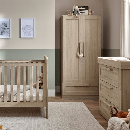 A cozy nursery with a crib, dresser, and wardrobe in neutral tones.