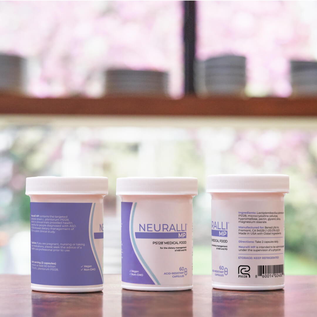 Three jars of skincare products on a wooden table.