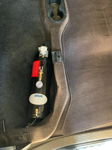 HornBlasters AC-M3 3-liter air tank with pressure gauge installed in vehicle cab footwell