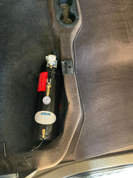 HornBlasters AC-M3 3-liter air tank with pressure gauge installed in vehicle cab footwell