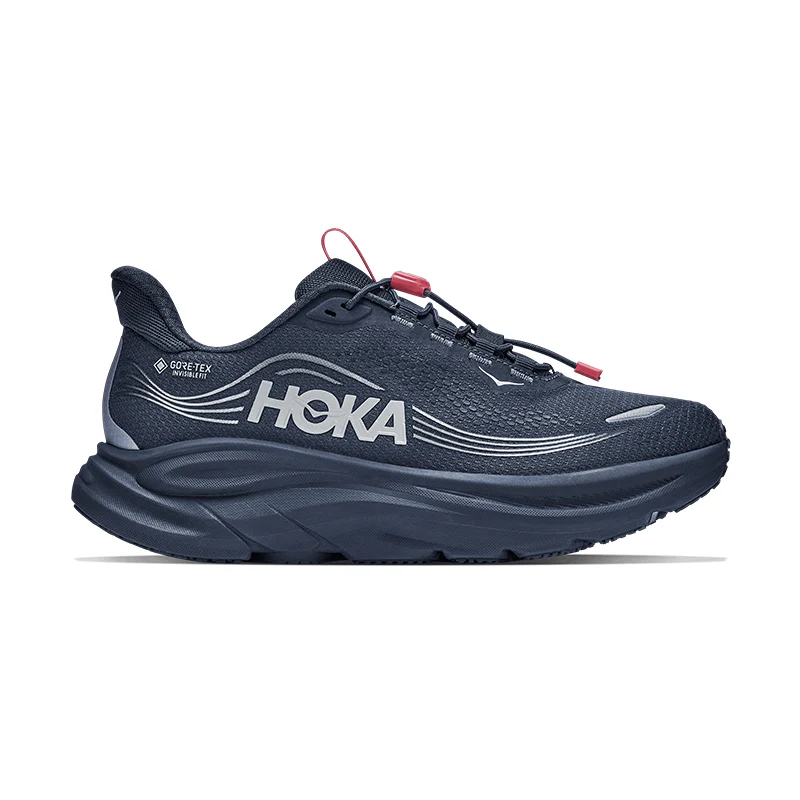 Navy blue Hoka running shoe with a thick sole and red accents.