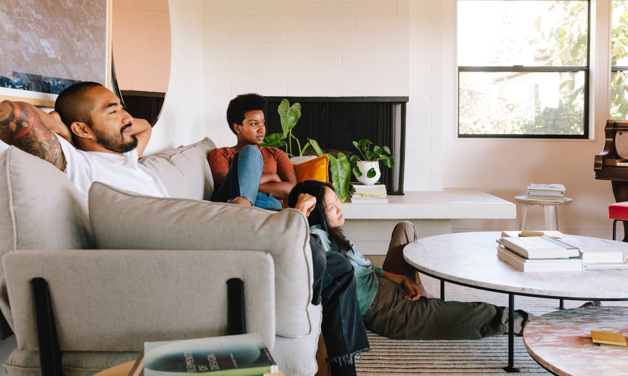 Watching TV with friends on couch with deep cushions