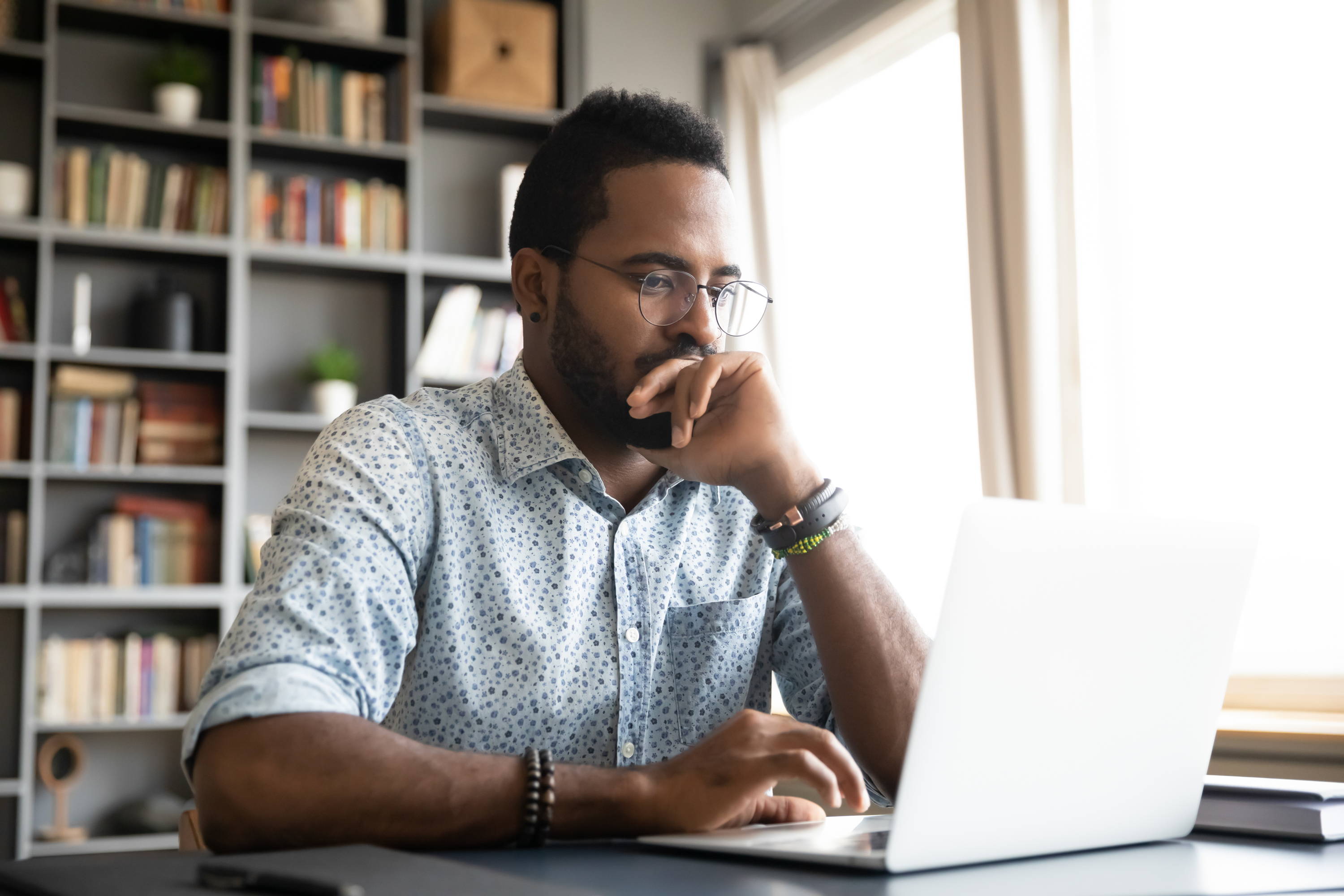 Man at laptop with headphones