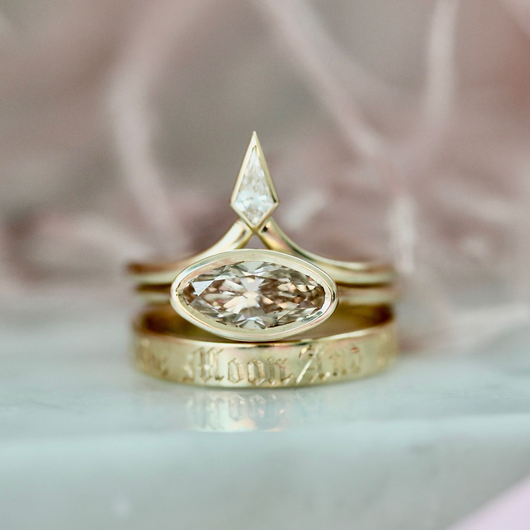 Oval cut east-west engagement ring in stack 