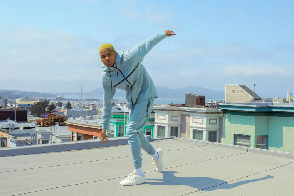 male model on rooftop wearing particle matching set in blue