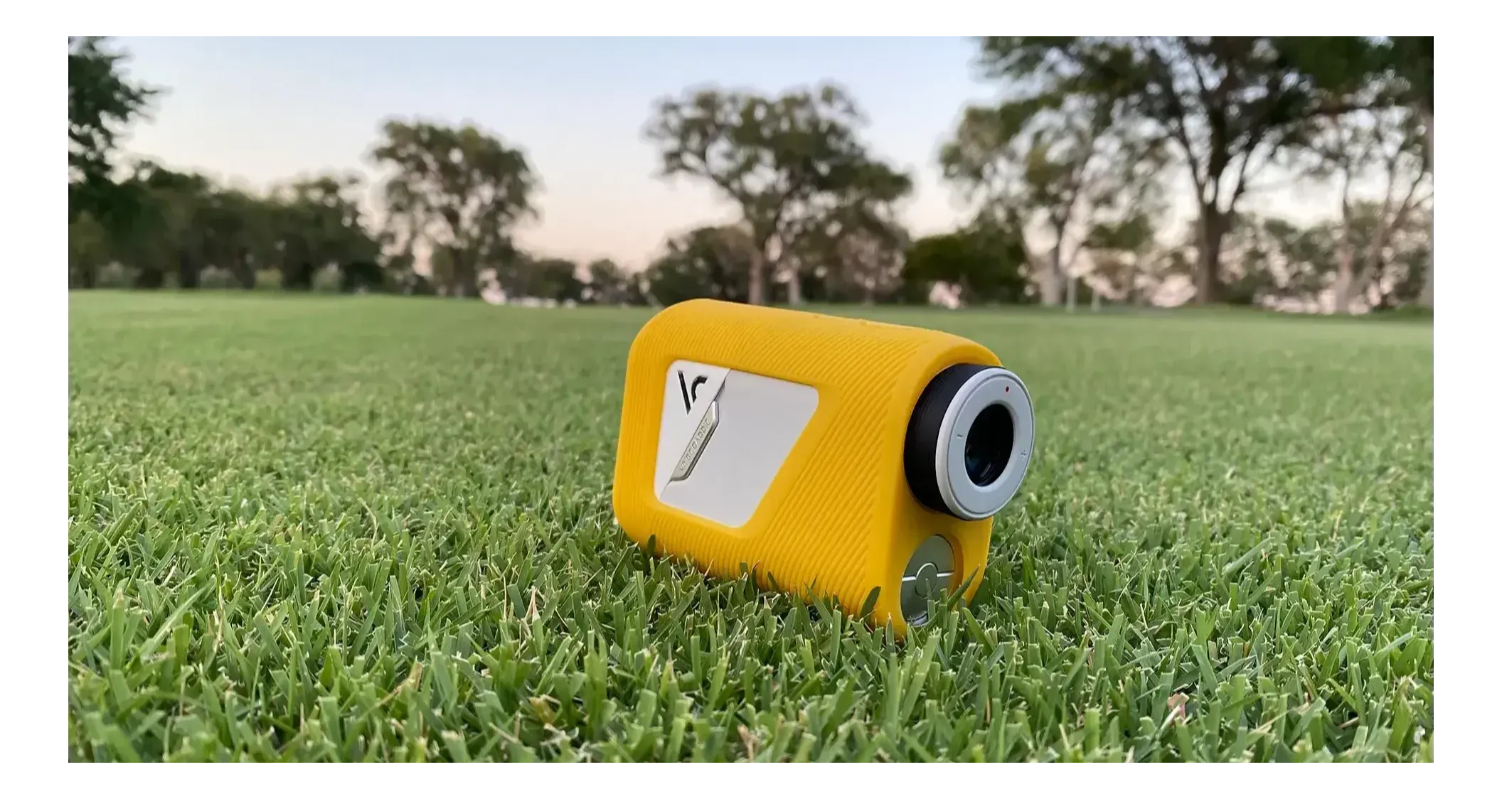The Voice Caddie TL1 golf rangefinder with yellow protective sleeve on the golf course
