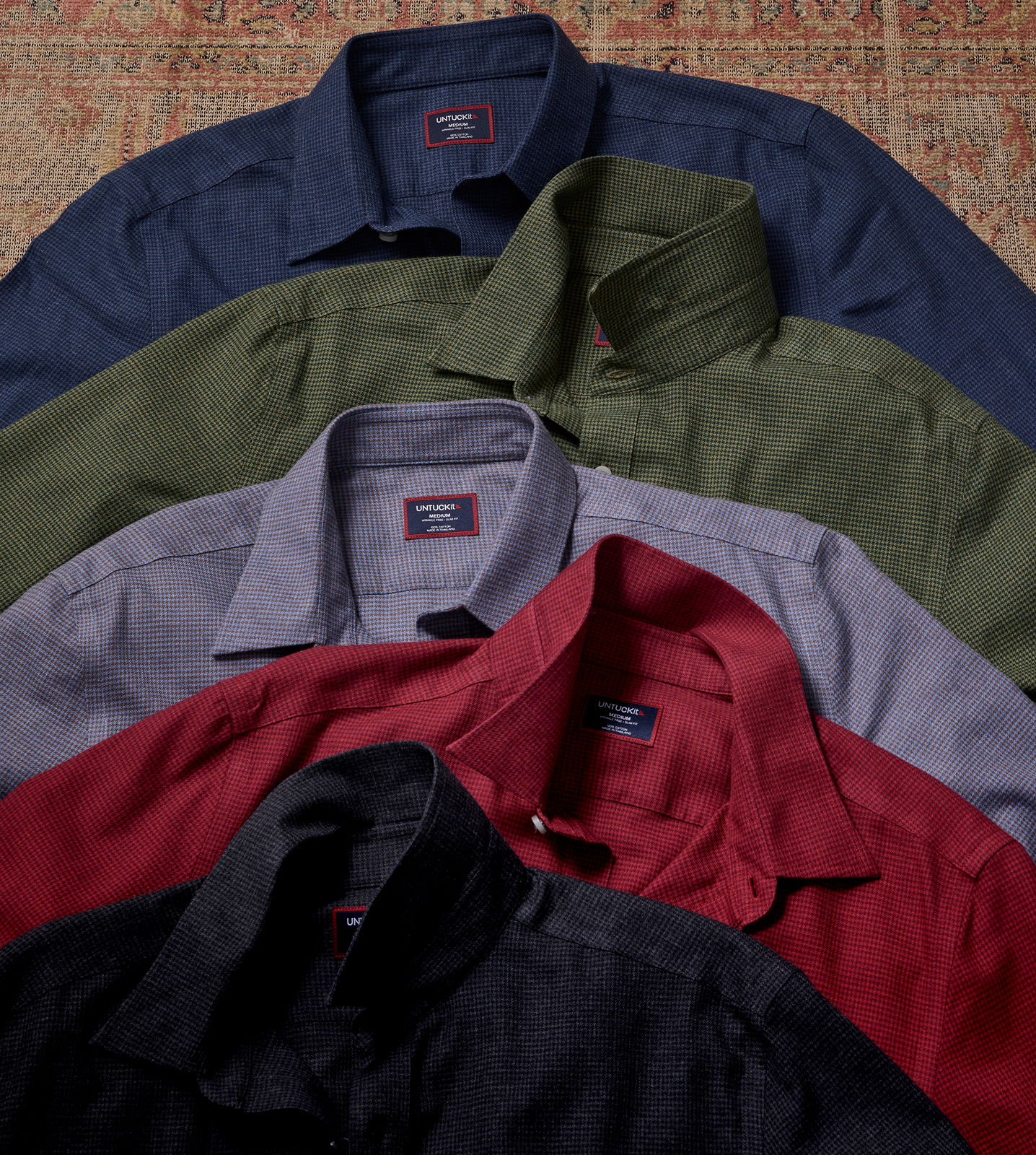 A stack of collared shirts in various colors.