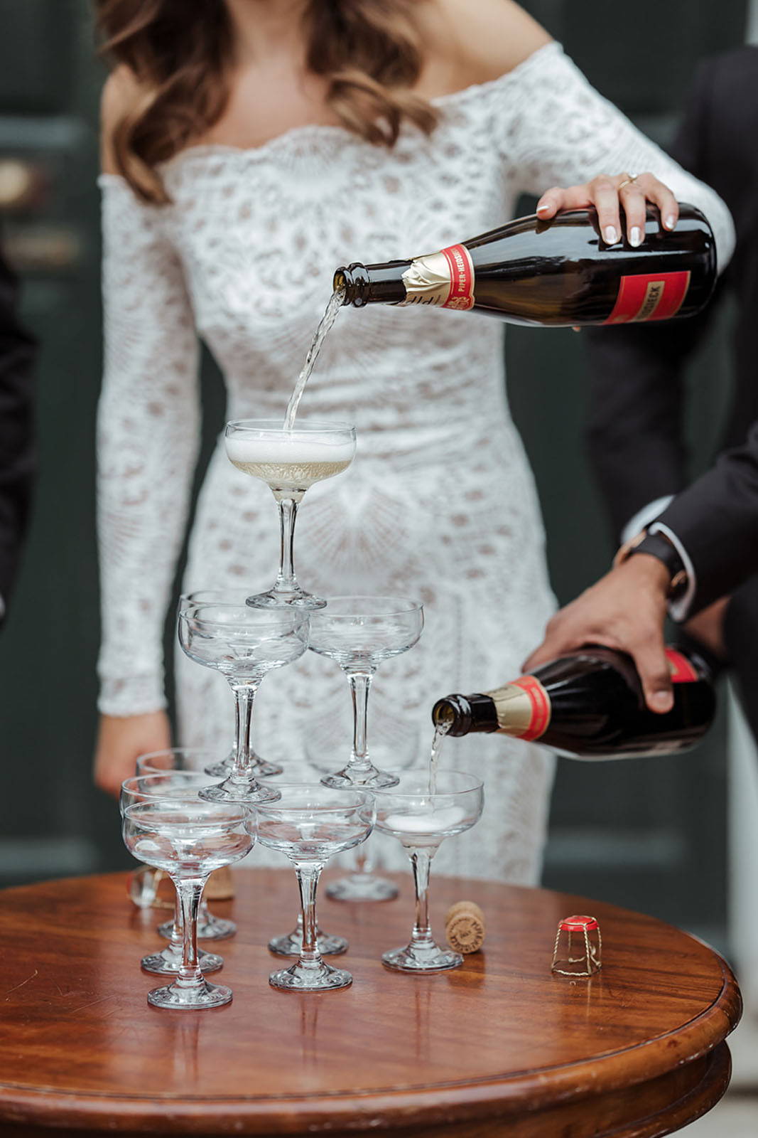 Bride and groom, serving champagne coupes