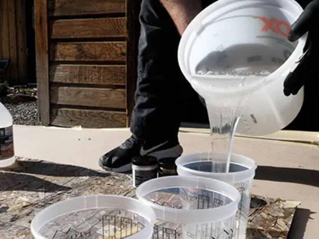 Pouring epoxy into other container.