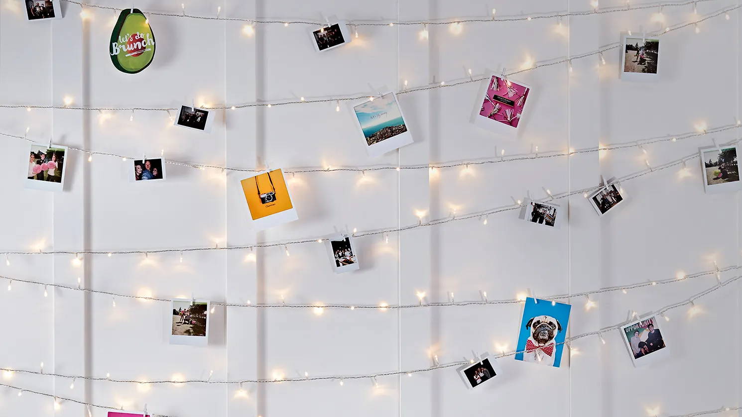Fairy light wall illuminated with images attached to it