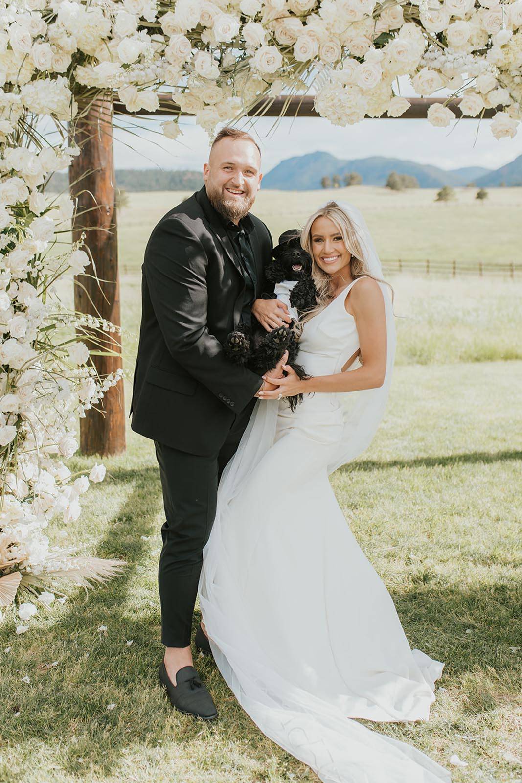 bride and groom, sharing a family time with their dog