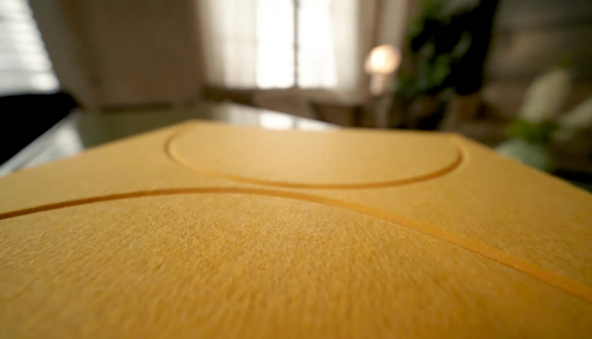 Close-up of the yellow felt surface of an ofinto Cubox Soft Panel, showing its texture and embossed grooved pattern.