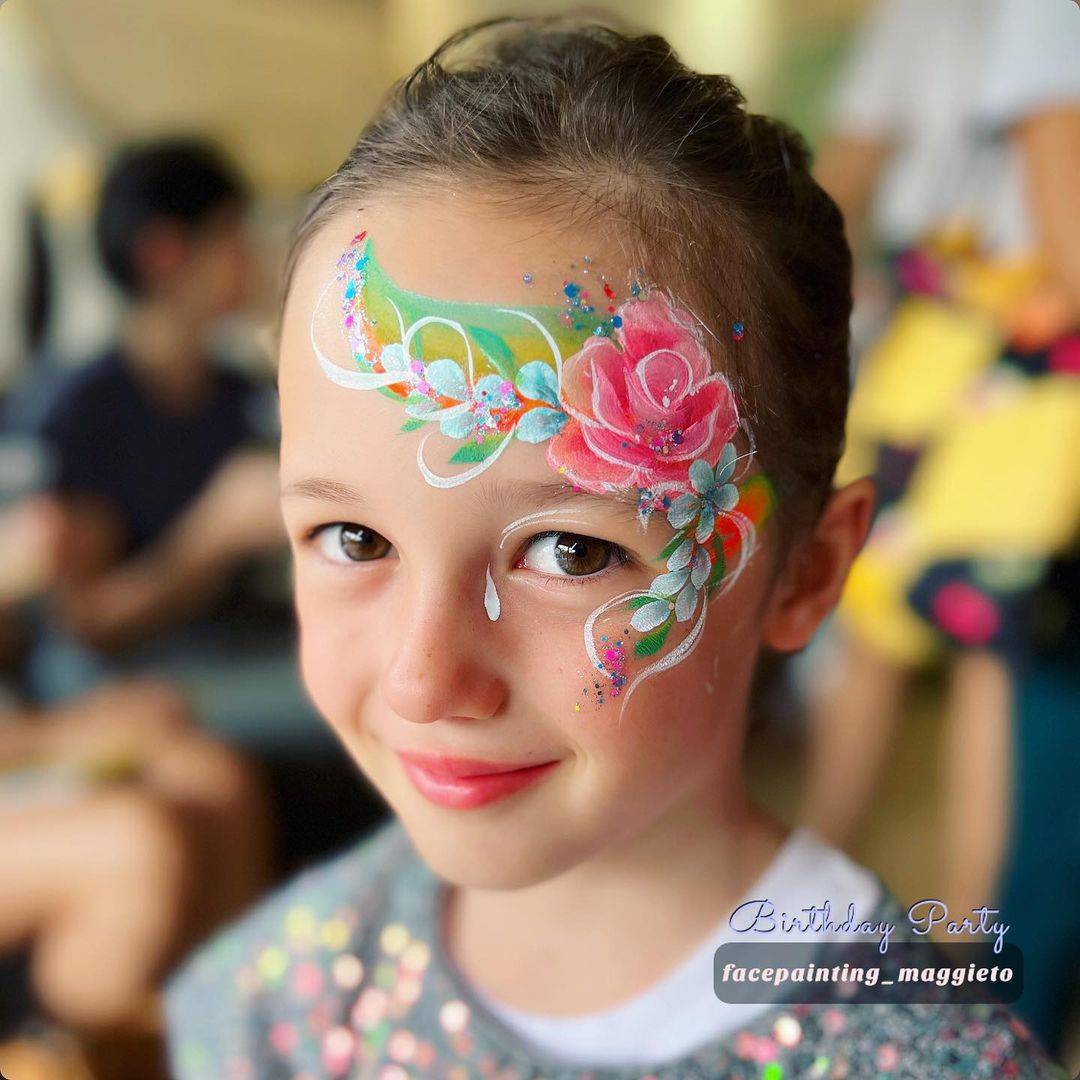 pretty rose face paint on temple