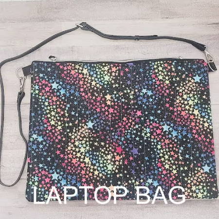 A colorful diy laptop bag made out of black fabric with stars
