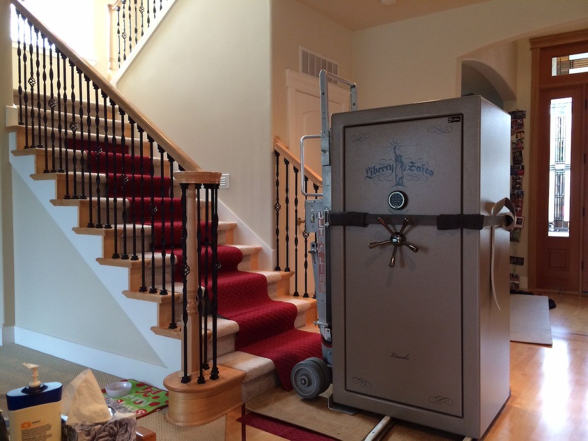 A large safe positioned near a staircase in a home interior.