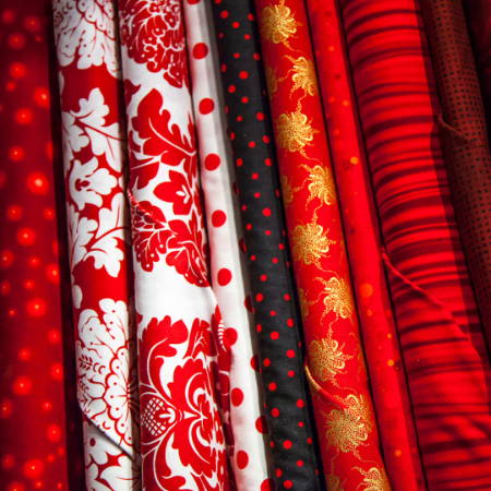 Fabrics with red prints organized and neatly folded