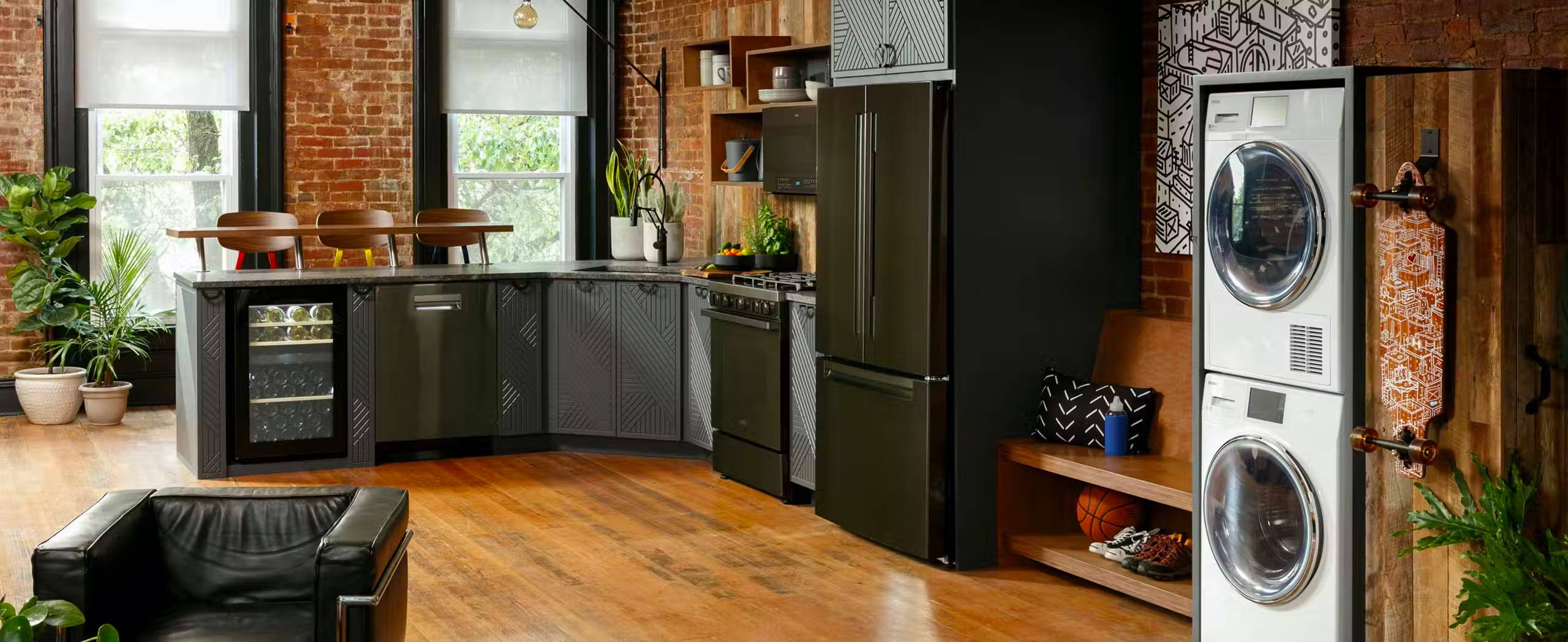 Kitchen with black Haier appliances and white stacked washer and dryer