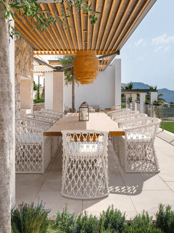 Boxhill's Amelia Outdoor Dining Chair at a Coastal Modern styled outdoor dining area.