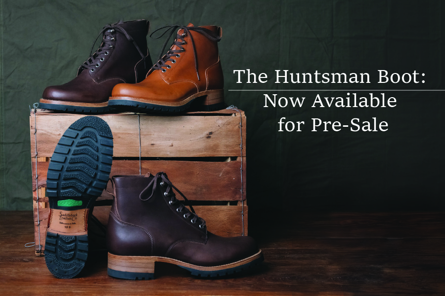 Three pairs of boots on a wooden crate with promotional text.